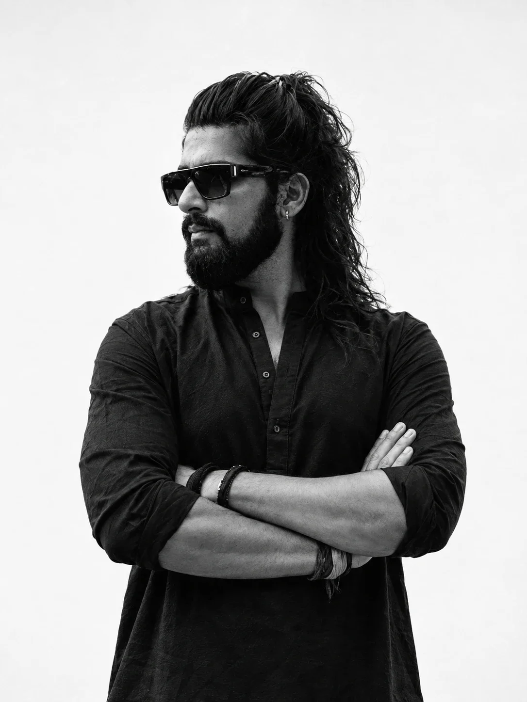 Black and white portrait of Prashant Verma in sunglasses and a black shirt, arms crossed